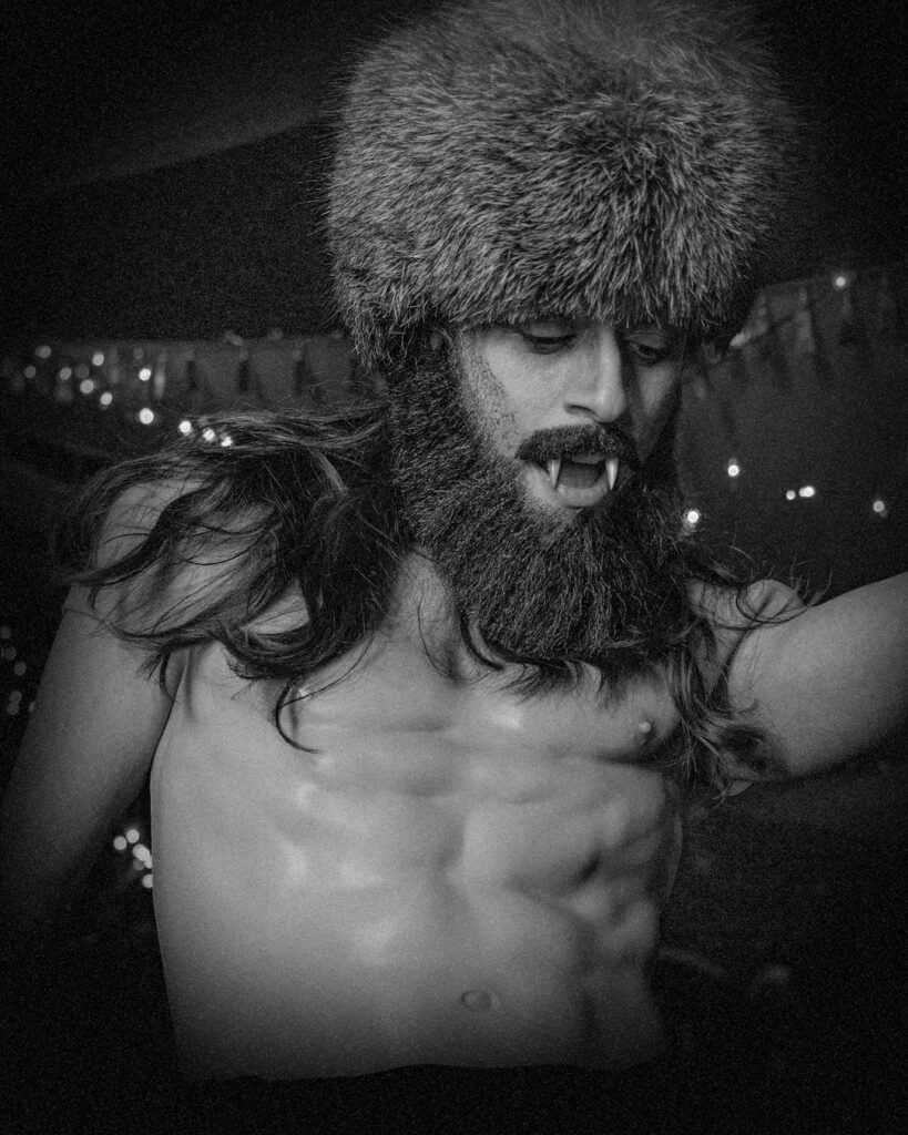 TRT The bare-chested Sir TRT poses for the camera, baring his vampire fangs.
