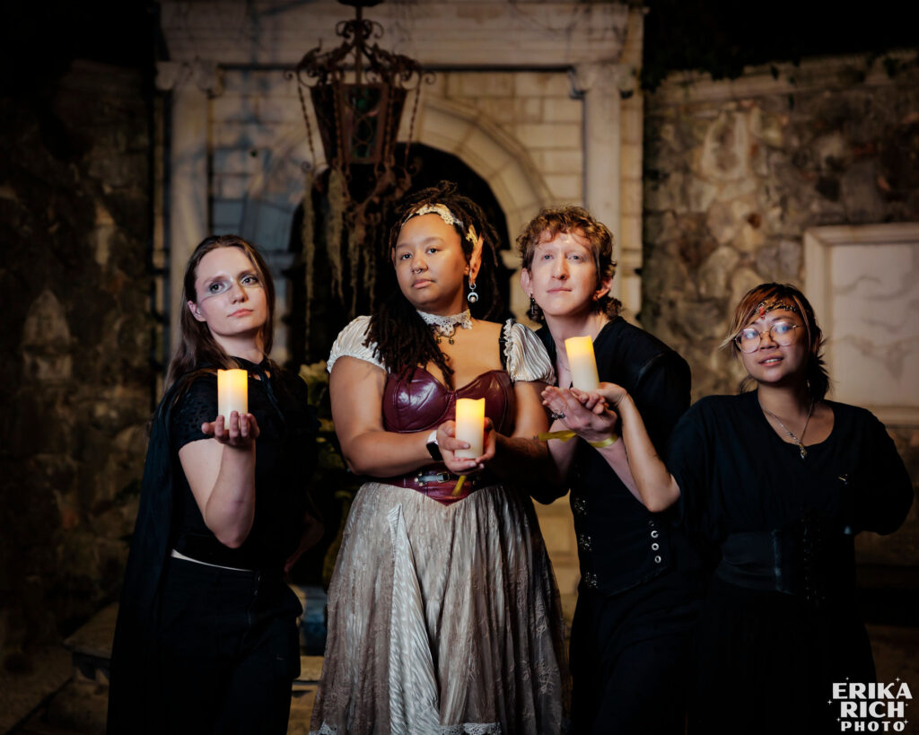 fiery talon Amanda Turner and the Fiery Talon crew pose for a portrait in fantasy garb. Each person holds a candle aloft.